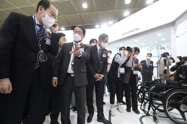 WIS 2022 KT 전시관에서 KT 구현모(왼쪽 둘째) 대표가 대통령직 인수위원회 권영세(왼쪽 첫째) 부위원장에게 AIoT 전동 휠체어를 설명하고 있다. / 사진=KT