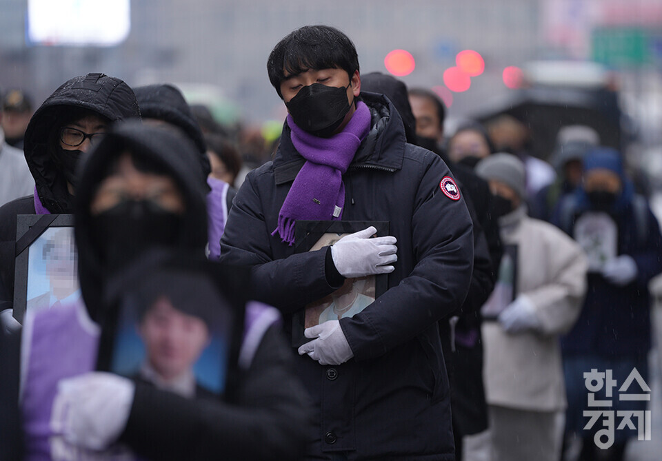 ​10·29 이태원참사 유가족협의회와 시민대책회의가 17일 오후 서울 중구 서울광장 합동분향소에서 '이태원 참사 유가족 침묵의 영정 행진'을 열고 있다. 행진에 참가한 유가족들이 영정을 품에 안고서 용산 대통령 집무실 앞까지 행진하고 있다. /최대성 기자 dpdaesung@sporbiz.co.kr 2024.01.17.