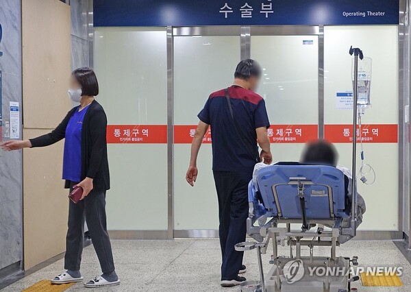  전공의 집단행동이 이어지고 있는 27일 서울의 한 대학병원에서 의료진이 환자와 이동하고 있다.  /연합뉴스