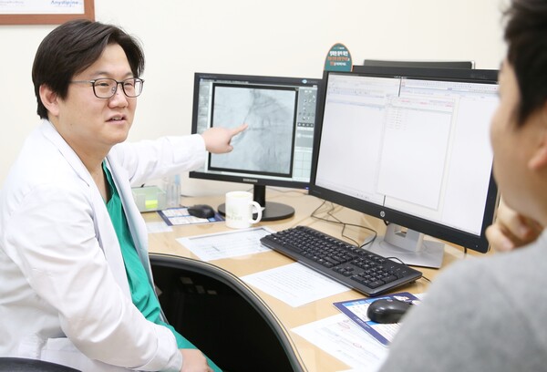 안정민 서울아산병원 심장내과 교수가 관상동맥 중재시술을 받은 환자를 진료하고 있다./서울아산병원 제공