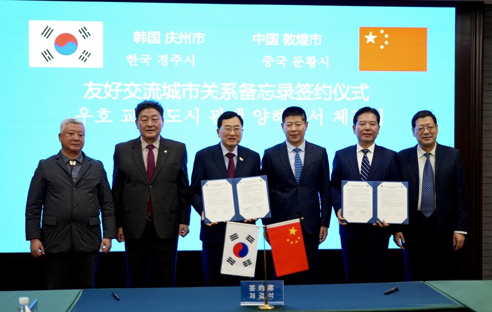 협정서 교환 후 기념촬영(좌측 세 번째부터 주낙영 경주시장, 왕엔췬 둔황시 당서기, 주젠쥔 둔황시장). 사진=경주시